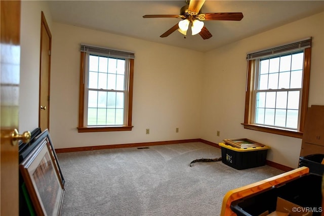 bedroom with baseboards, carpet floors, visible vents, and a ceiling fan