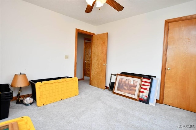 sitting room featuring ceiling fan and carpet flooring