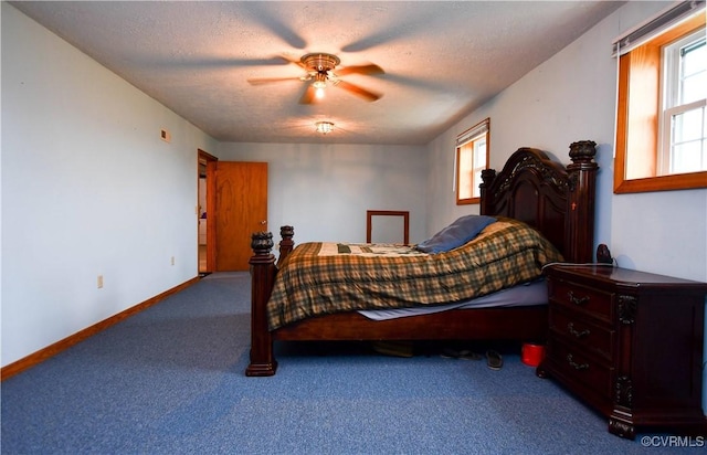 carpeted bedroom with a ceiling fan, baseboards, and a textured ceiling