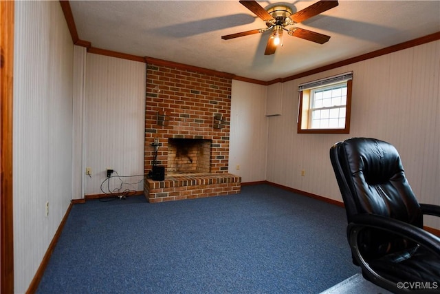 unfurnished office featuring carpet, a fireplace, baseboards, ceiling fan, and ornamental molding