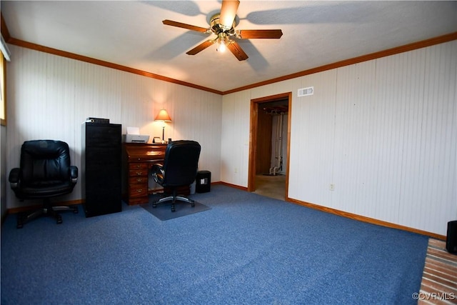 carpeted home office with baseboards, visible vents, ceiling fan, and ornamental molding