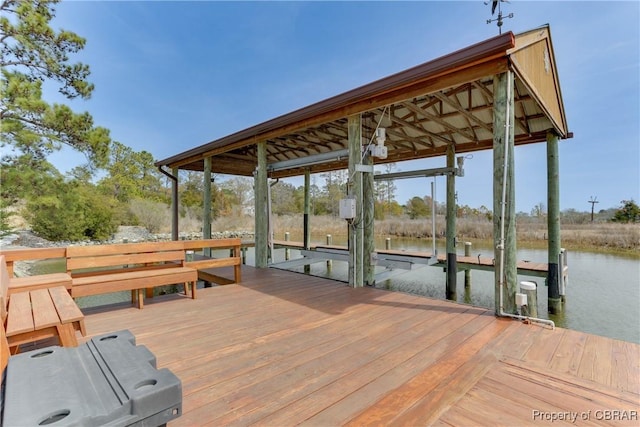view of dock with boat lift and a water view