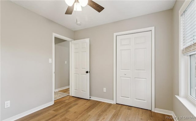 104 Martin Ln, Bohannon, VA 23021 - unfurnished bedroom featuring light wood-style flooring, multiple windows, and baseboards