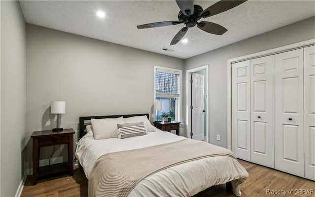 104 Martin Ln, Bohannon, VA 23021 - bedroom with a closet, visible vents, a textured ceiling, and wood finished floors