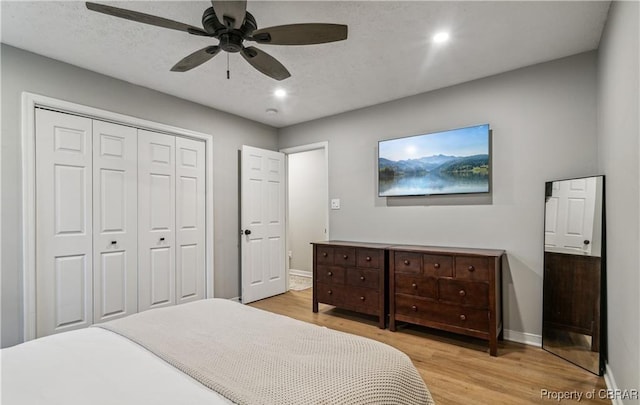 104 Martin Ln, Bohannon, VA 23021 - bedroom featuring a closet, baseboards, wood finished floors, and a textured ceiling