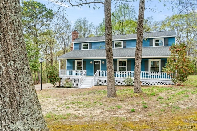 view of front of house with a chimney, roof with shingles, and covered porch