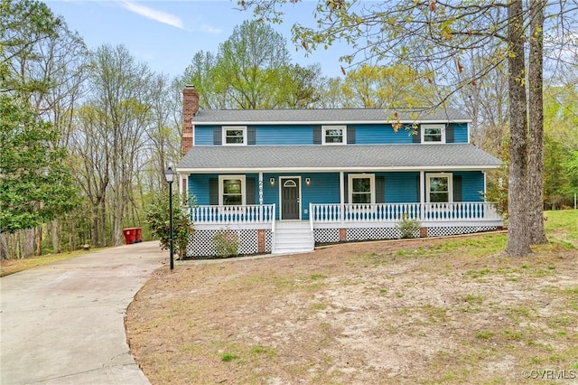 2600 Rosebud Ct, Prince George, VA 23875 - view of front facade with covered porch, concrete driveway, and a chimney
