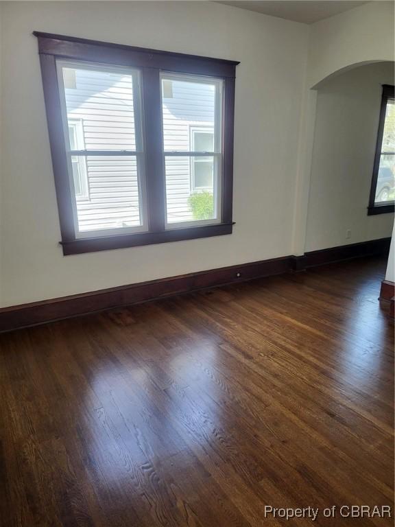 325 Hampton Roads Ave, Hampton, VA 23661 - unfurnished room with arched walkways, dark wood-style flooring, and baseboards