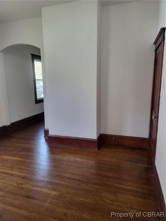 325 Hampton Roads Ave, Hampton, VA 23661 - spare room with arched walkways, baseboards, and dark wood finished floors