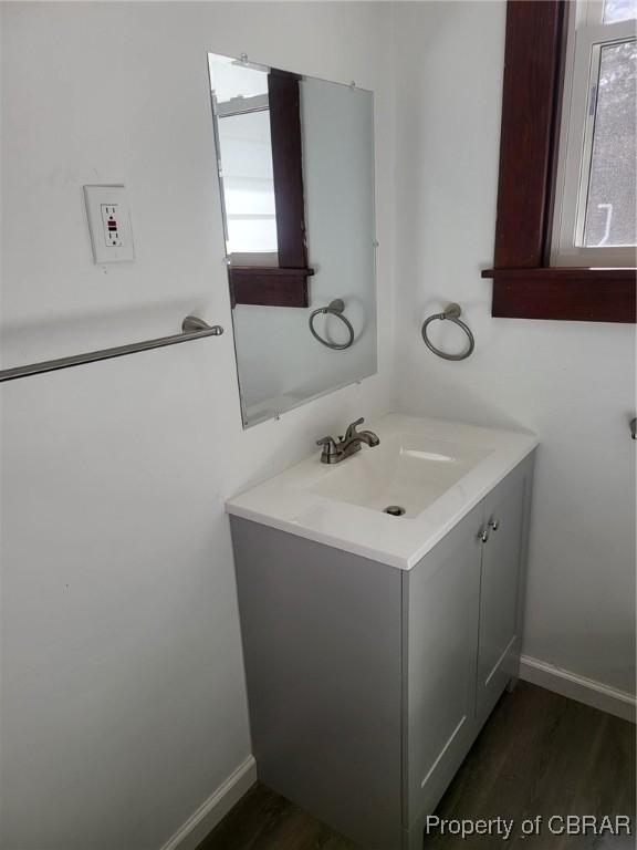 325 Hampton Roads Ave, Hampton, VA 23661 - bathroom with wood finished floors, vanity, and baseboards