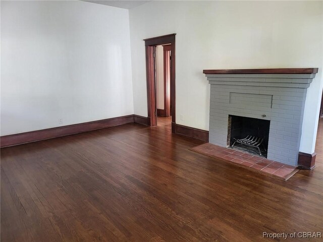 325 Hampton Roads Ave, Hampton, VA 23661 - unfurnished living room with a fireplace, baseboards, and wood finished floors