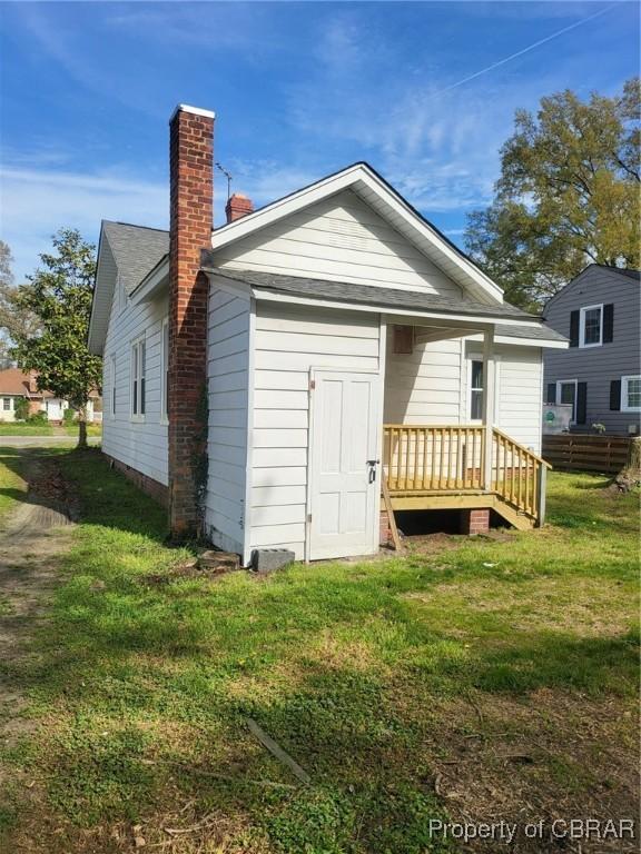 325 Hampton Roads Ave, Hampton, VA 23661 - rear view of house featuring a yard and a chimney