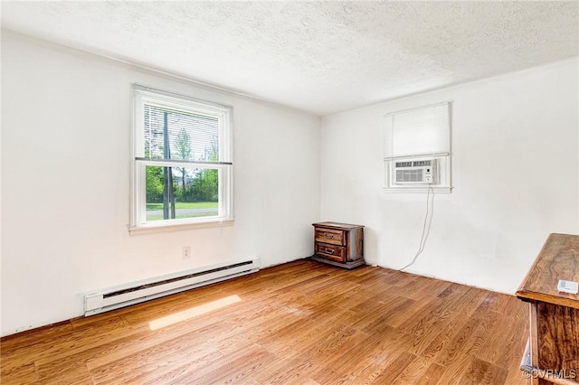 12161 Ashland Heights Rd, Ashland, VA 23005 - empty room with baseboard heating, wood finished floors, cooling unit, and a textured ceiling