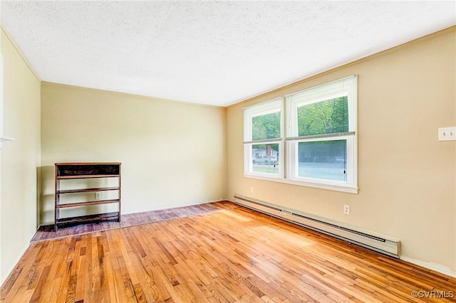 12161 Ashland Heights Rd, Ashland, VA 23005 - interior space featuring a baseboard heating unit, a textured ceiling, and wood-type flooring