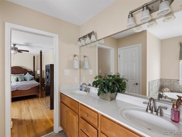 9208 Gayton Rd, Glen Allen, VA 23229 - ensuite bathroom with double vanity, a bath, a ceiling fan, and wood finished floors