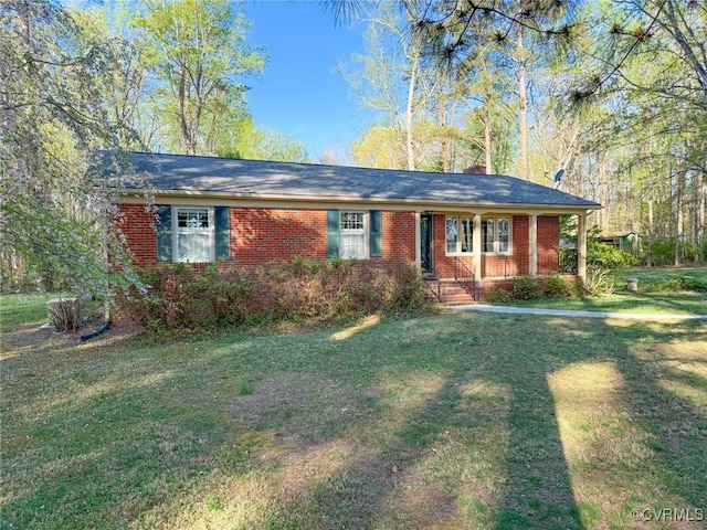 ranch-style house with a front yard and brick siding