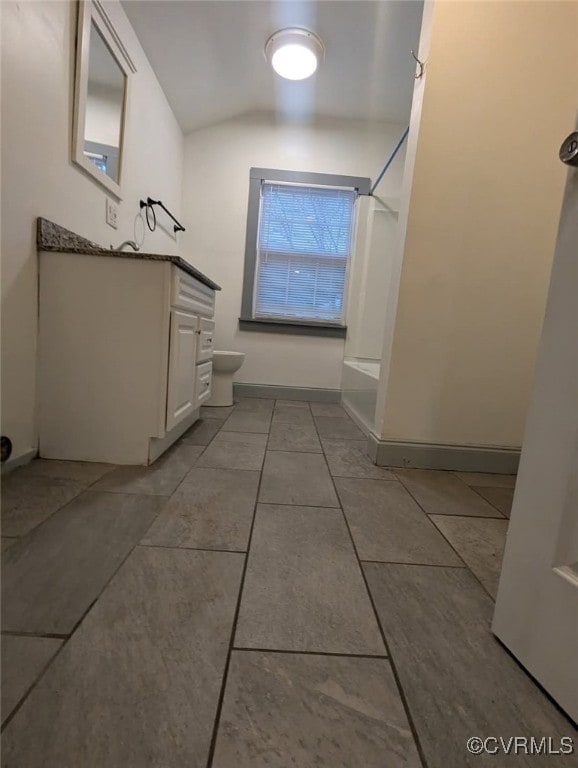 6080 Buckley Hall Rd, Mathews, VA 23035 - full bath featuring vanity, vaulted ceiling, shower / bath combination, tile patterned floors, and baseboards