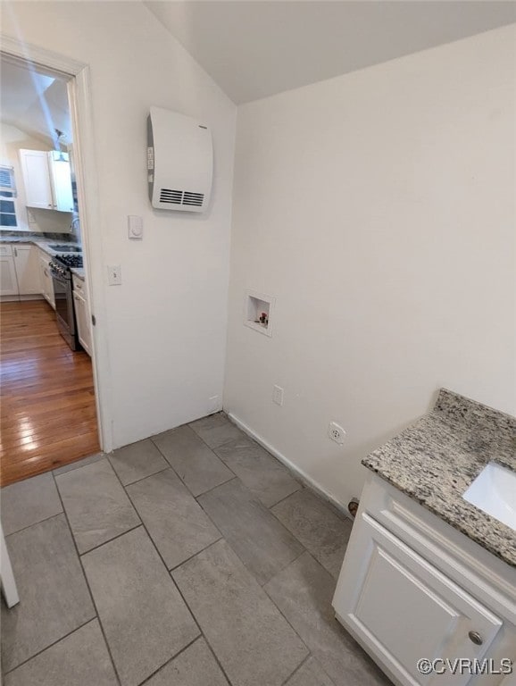 6080 Buckley Hall Rd, Mathews, VA 23035 - laundry area with laundry area, light tile patterned floors, washer hookup, a sink, and an AC wall unit