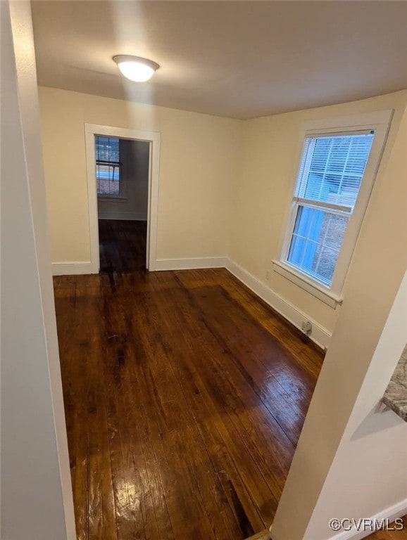 6080 Buckley Hall Rd, Mathews, VA 23035 - empty room with dark wood-type flooring, baseboards, and a healthy amount of sunlight