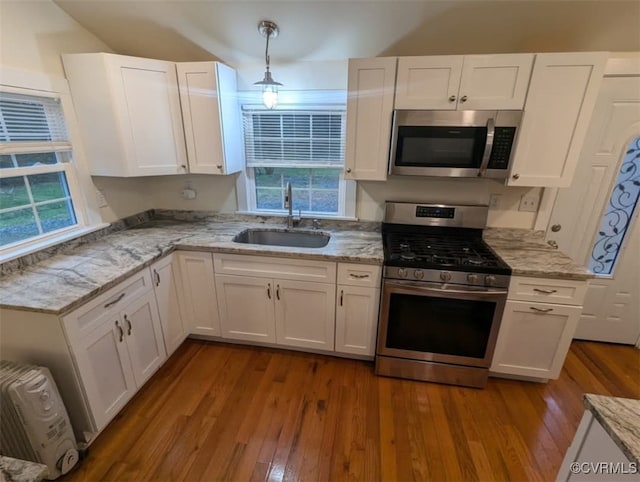 6080 Buckley Hall Rd, Mathews, VA 23035 - kitchen with light stone countertops, dark wood-type flooring, white cabinets, appliances with stainless steel finishes, and a sink