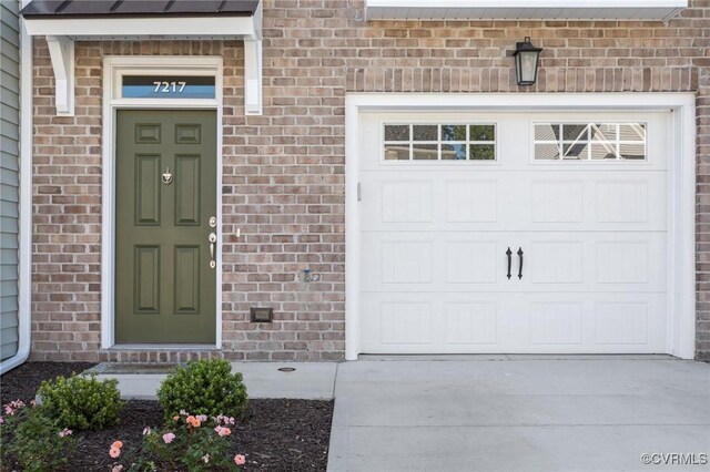 7217 Leire Ln, Chesterfield, VA 23832 - doorway to property with concrete driveway, brick siding, and an attached garage