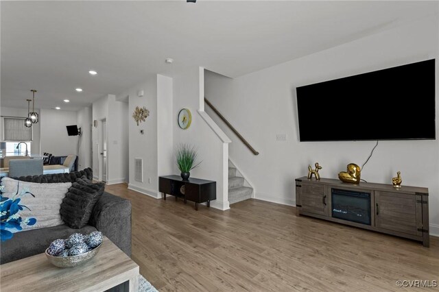 7217 Leire Ln, Chesterfield, VA 23832 - living room featuring stairs, light wood-type flooring, recessed lighting, and baseboards