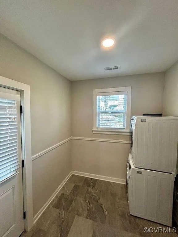 3002 5th Ave, Richmond, VA 23222 - laundry room with stacked washer / dryer, laundry area, baseboards, and visible vents