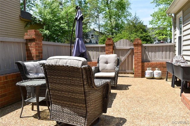 view of patio with a gate and fence
