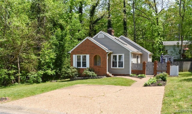 bungalow-style house featuring a front yard, a chimney, a gate, brick siding, and fence