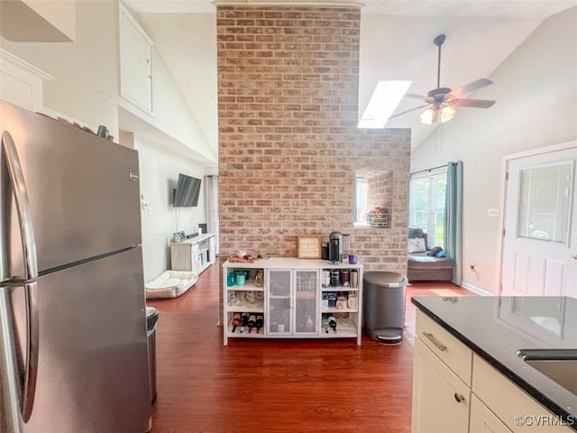 kitchen featuring dark wood-style floors, ceiling fan, freestanding refrigerator, and high vaulted ceiling