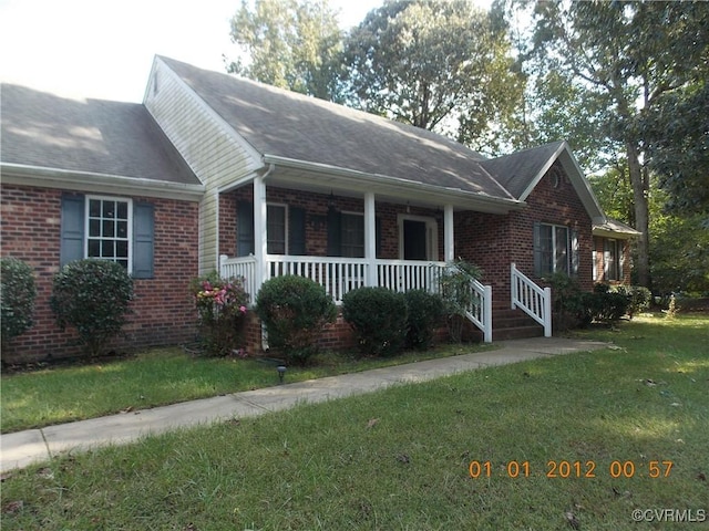 8304 Elizabeth Ann Dr, Hanover, VA 23111 - view of front of property featuring brick siding, a front yard, covered porch, and roof with shingles