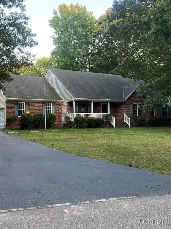 8304 Elizabeth Ann Dr, Hanover, VA 23111 - ranch-style home with brick siding, a front yard, a porch, and a garage