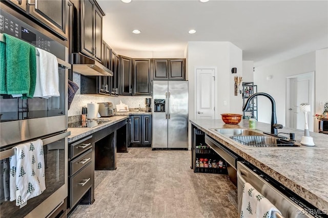 4341 Kenmare Ct, Richmond, VA 23234 - kitchen with appliances with stainless steel finishes, a sink, under cabinet range hood, light countertops, and recessed lighting