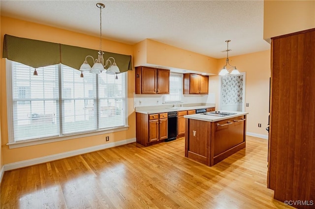 240 Lighthouse Pointe, North Prince George, VA 23860 - kitchen featuring brown cabinetry, light countertops, a kitchen island, light wood finished floors, and pendant lighting