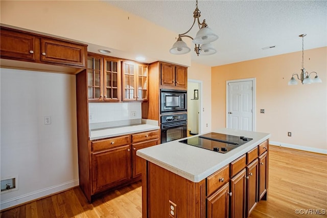 240 Lighthouse Pointe, North Prince George, VA 23860 - kitchen featuring a chandelier, black appliances, brown cabinets, baseboards, and light wood-style flooring