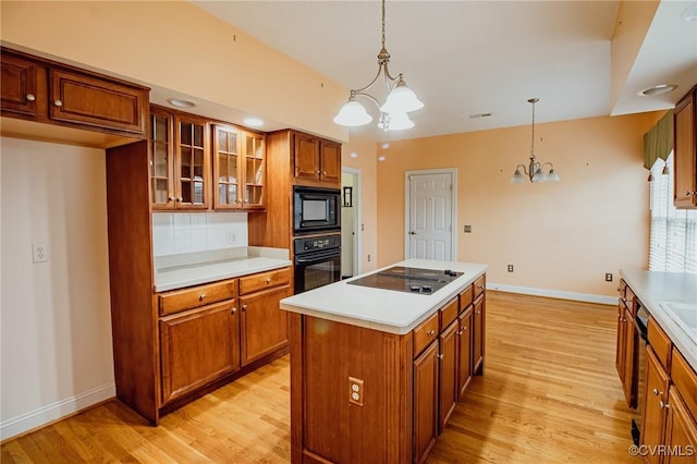 240 Lighthouse Pointe, North Prince George, VA 23860 - kitchen featuring black appliances, a chandelier, brown cabinets, and light wood-style flooring
