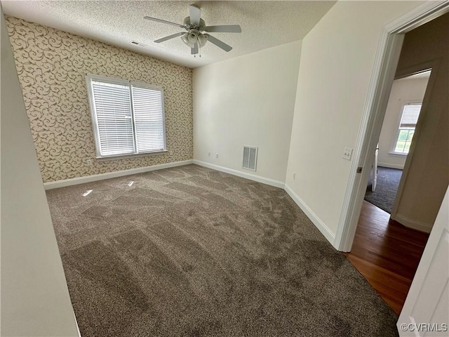 240 Lighthouse Pointe, North Prince George, VA 23860 - empty room with a textured ceiling, ceiling fan, wallpapered walls, and carpet