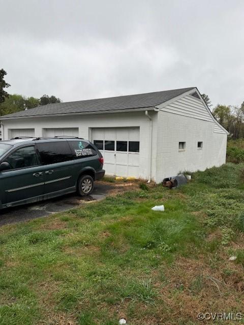 2005 Hungary Rd, Henrico, VA 23228 - view of home's exterior with a yard, a garage, driveway, and an outdoor structure