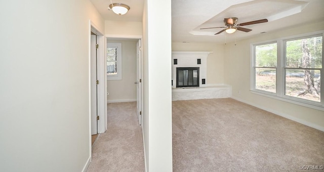 interior space featuring baseboards and light colored carpet