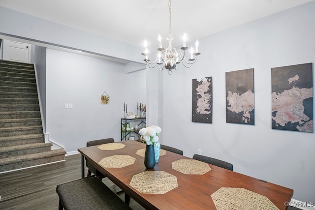 dining room featuring an inviting chandelier, dark wood-style floors, and stairway