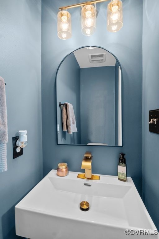 bathroom featuring visible vents and a sink