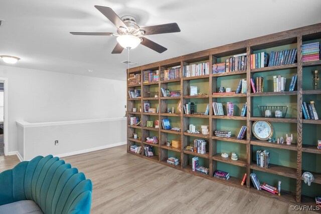 sitting room featuring baseboards, ceiling fan, visible vents, and wood finished floors