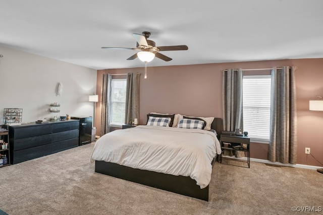 carpeted bedroom with baseboards and a ceiling fan
