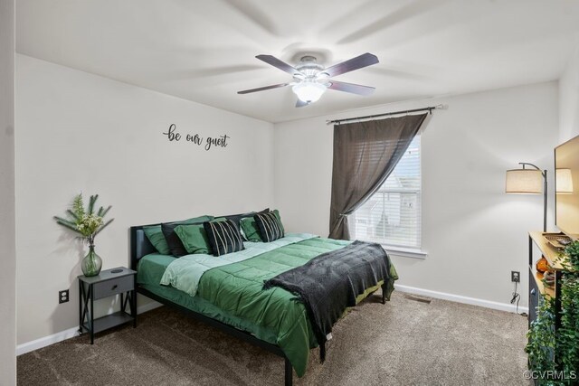 carpeted bedroom with baseboards, a ceiling fan, and visible vents