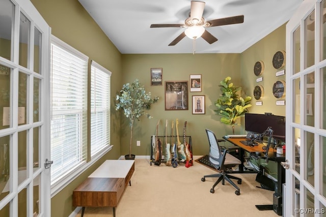 carpeted office space featuring plenty of natural light, french doors, and ceiling fan
