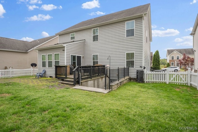 rear view of house with a yard, a gate, a wooden deck, and a fenced backyard