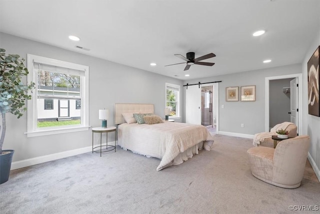 bedroom with a barn door, baseboards, visible vents, and recessed lighting
