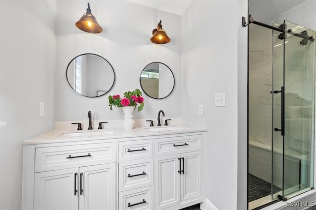 bathroom featuring a shower stall, a sink, and double vanity