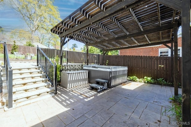 view of patio / terrace featuring a pergola, a hot tub, a fenced backyard, and stairway