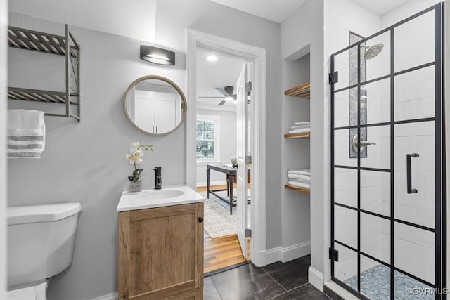 full bathroom featuring baseboards, built in features, a shower stall, and toilet